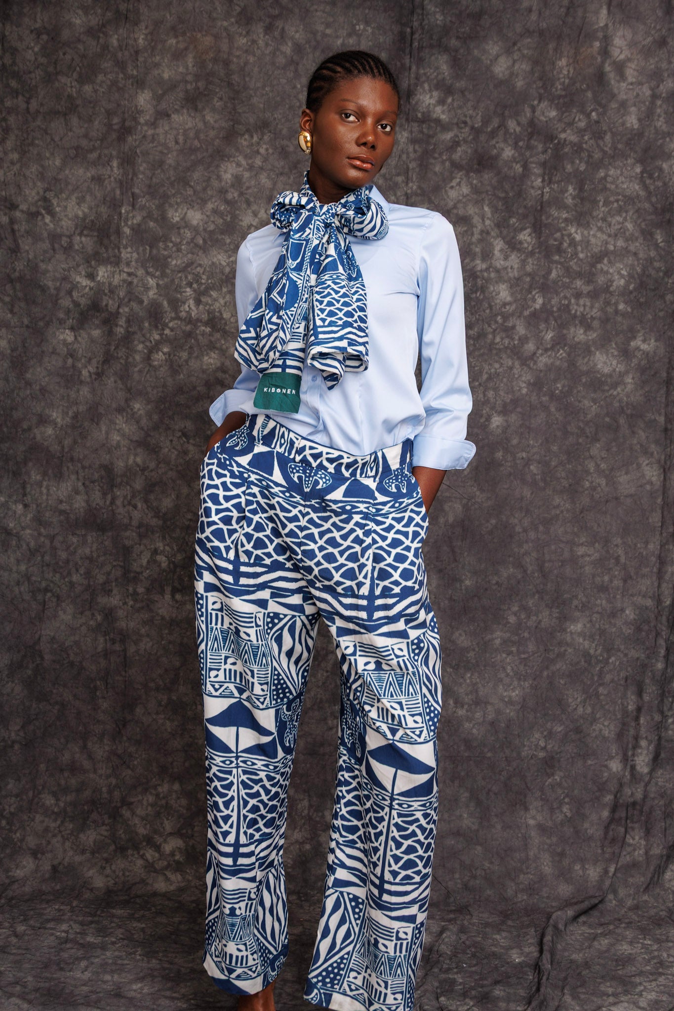 Model wearing Tchida Scarf tied around neck with matching print trousers
