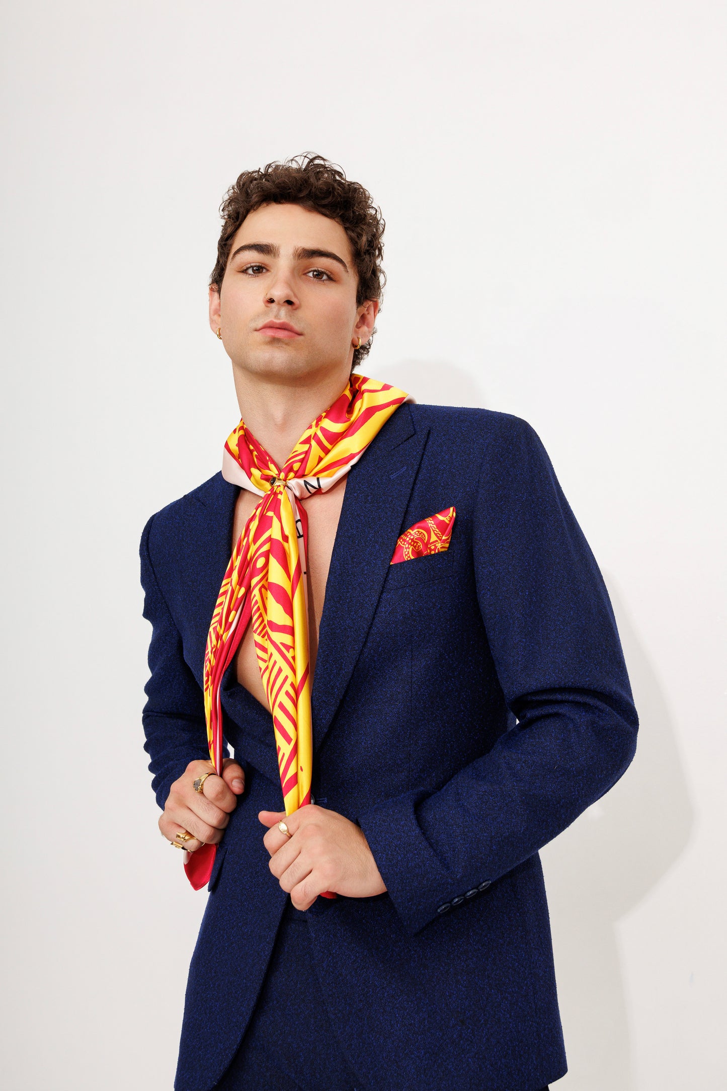 Model mid-closeup with scarf draped in formal setting