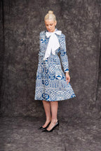 Model wearing Fatime Shirt Dress in blue heritage print with black heels