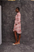 Model wearing Foumban Shirt Dress made from sustainable African fabric, side pose