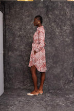 Model wearing Foumban Shirt Dress made from sustainable African fabric, side pose
