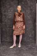 Model wearing Kadji Teo Toned Mocca Blouse styled with skirt, front view