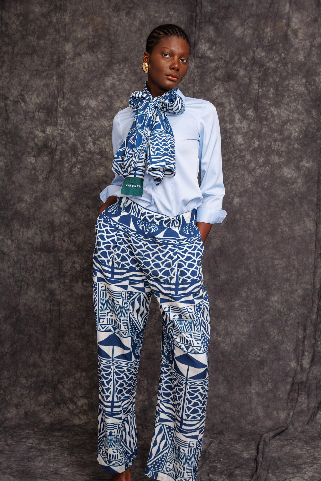 Model wearing Tchida Scarf tied around neck with matching print trousers